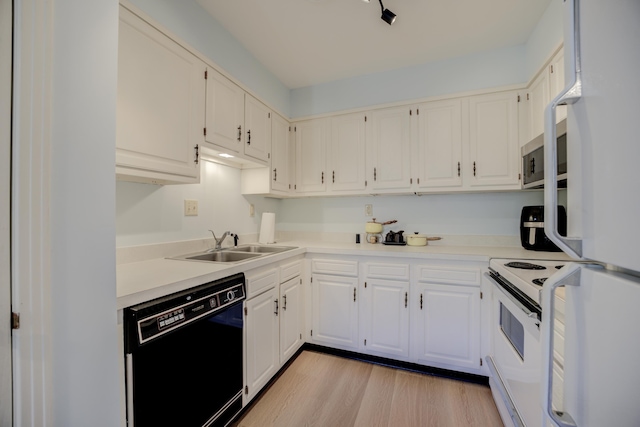 kitchen with white cabinets, light wood-type flooring, white appliances, and sink