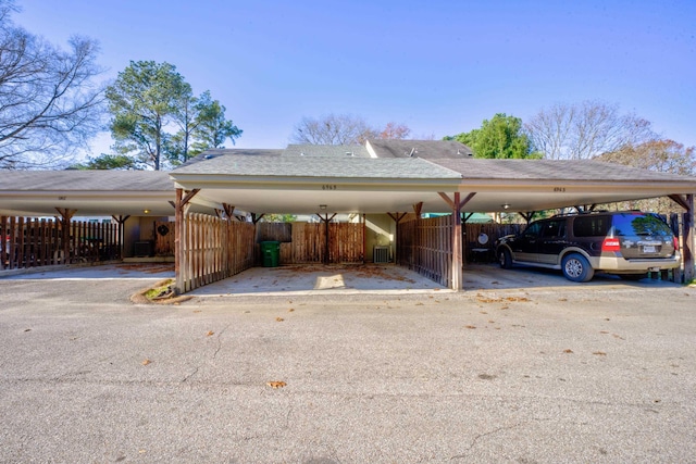 view of parking / parking lot featuring a carport