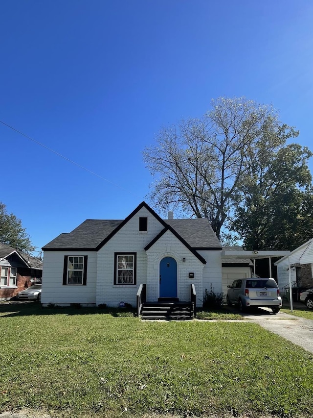 view of front of house with a front yard and a garage