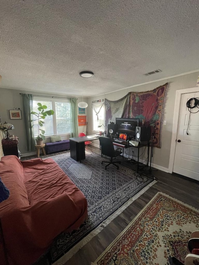 living room with wood-type flooring and a textured ceiling