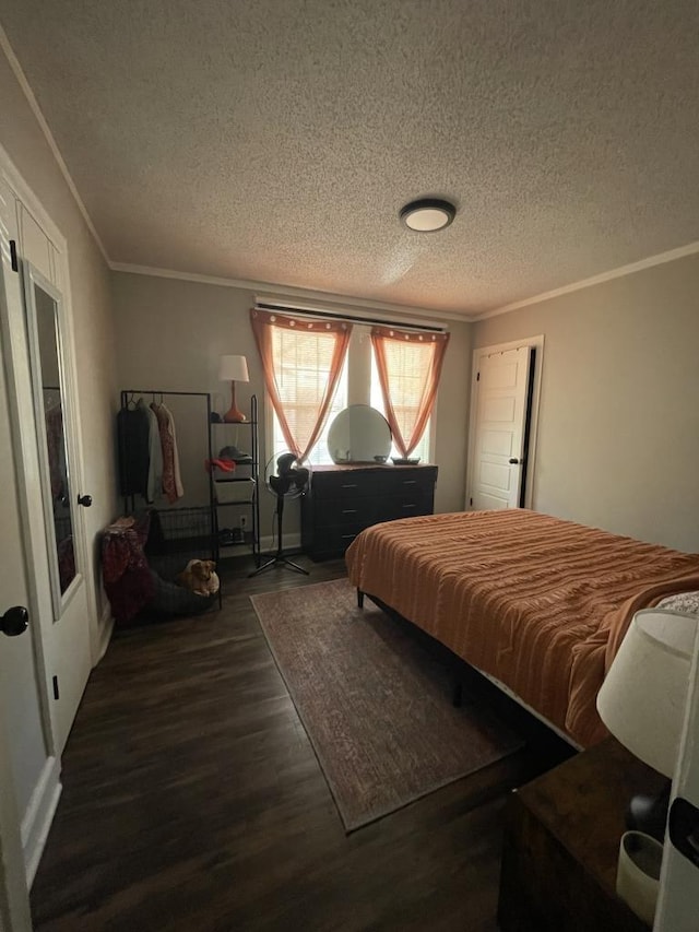 bedroom with crown molding, dark wood-type flooring, and a textured ceiling