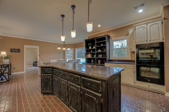 kitchen with dark brown cabinets, a kitchen island, double oven, and crown molding