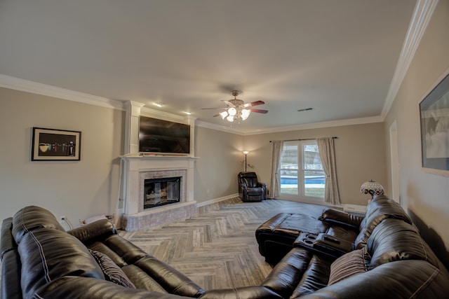 living room featuring parquet flooring, a large fireplace, ceiling fan, and crown molding