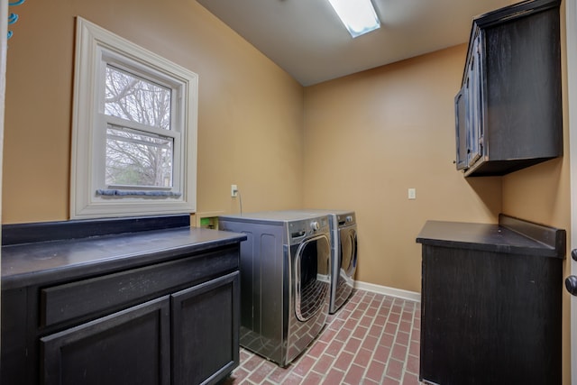 washroom featuring cabinets and independent washer and dryer