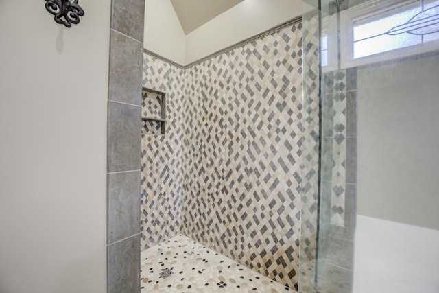 bathroom with tiled shower