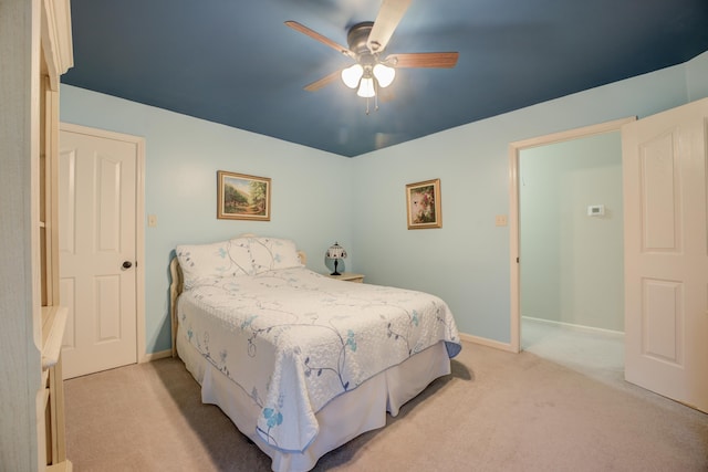 bedroom featuring ceiling fan and light carpet