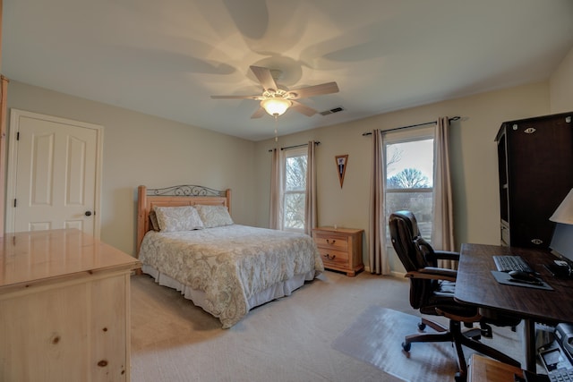 bedroom with ceiling fan and light carpet