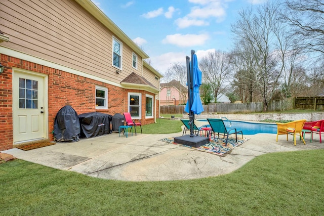 view of pool featuring a yard, area for grilling, and a patio area