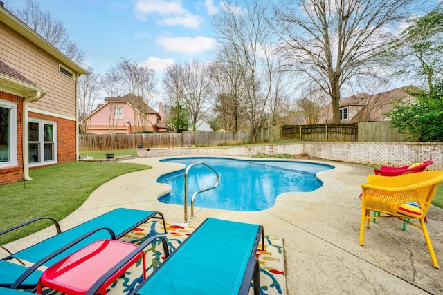 view of swimming pool with a patio area and a yard