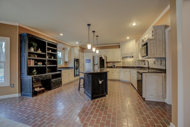 kitchen with decorative backsplash, a breakfast bar, black appliances, decorative light fixtures, and a center island