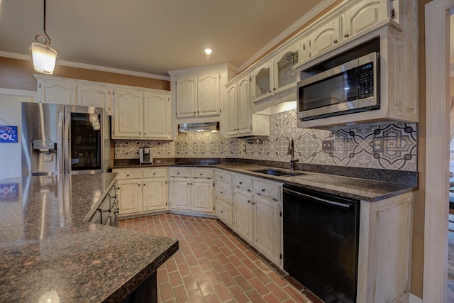 kitchen featuring tasteful backsplash, stainless steel appliances, crown molding, sink, and dark stone countertops