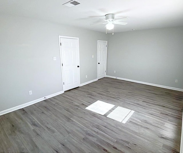 unfurnished room featuring ceiling fan and dark hardwood / wood-style flooring