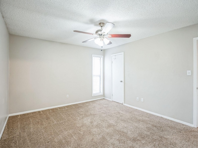 empty room with carpet floors and a textured ceiling