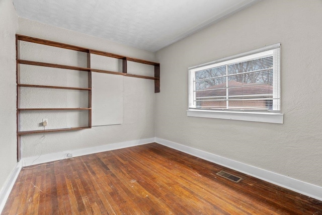 unfurnished room with wood-type flooring