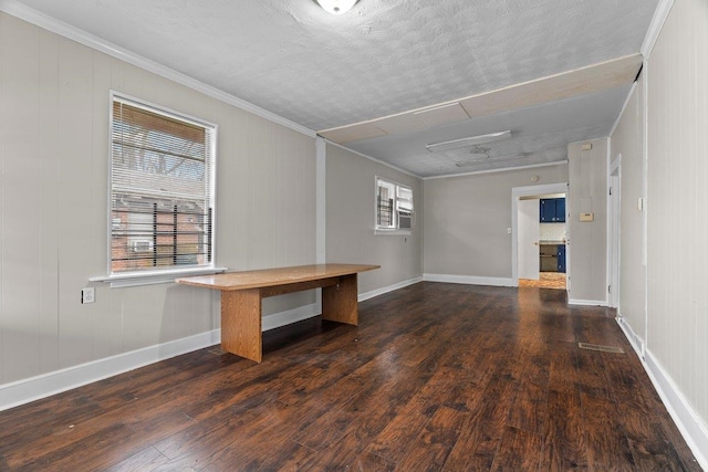 unfurnished room featuring crown molding, dark hardwood / wood-style flooring, and a textured ceiling