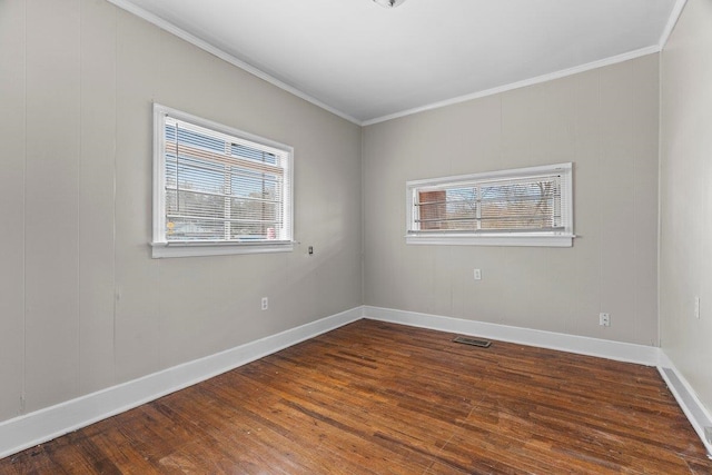 spare room featuring dark hardwood / wood-style floors and ornamental molding