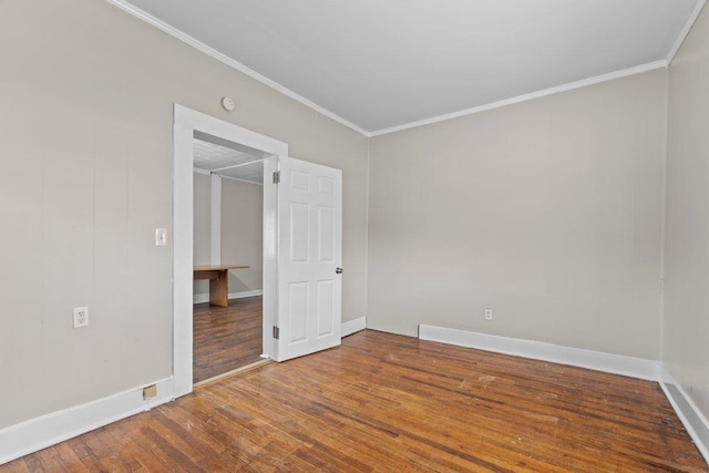 spare room featuring crown molding and hardwood / wood-style flooring