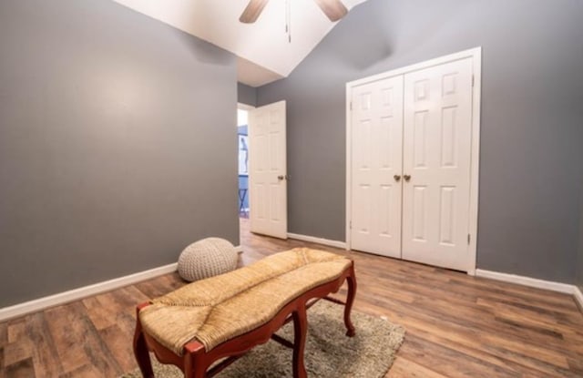 sitting room featuring hardwood / wood-style floors, ceiling fan, and lofted ceiling