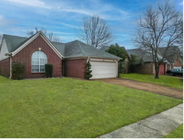 ranch-style house featuring a front yard and a garage