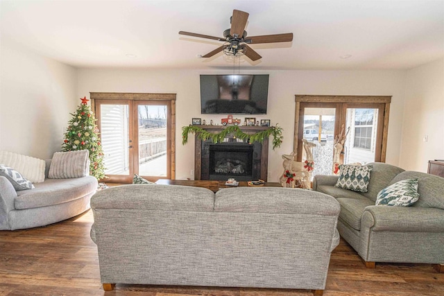 living room featuring ceiling fan, french doors, and dark wood-type flooring