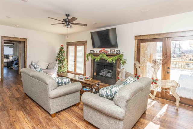 living room with ceiling fan, french doors, and hardwood / wood-style floors