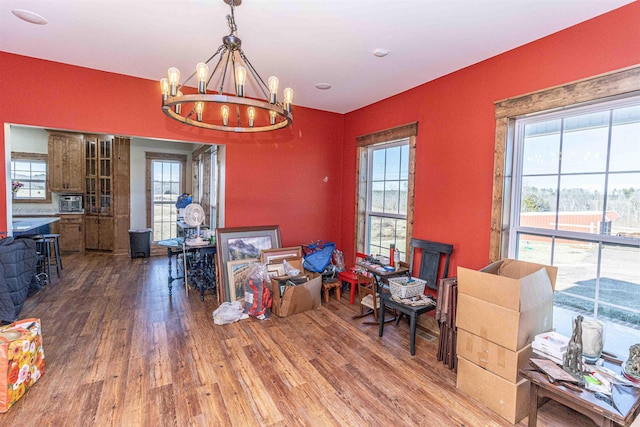 dining area featuring hardwood / wood-style floors and an inviting chandelier