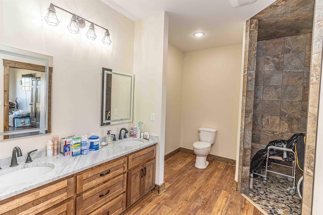 bathroom with toilet, vanity, and hardwood / wood-style flooring