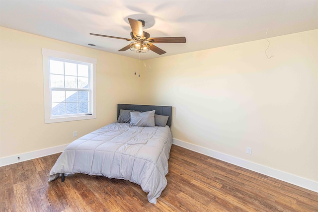 bedroom featuring ceiling fan and dark hardwood / wood-style floors