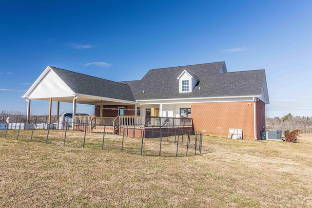 back of house featuring a lawn and central air condition unit