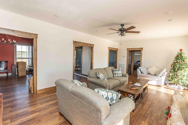 living room with dark hardwood / wood-style floors and ceiling fan