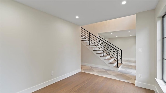 stairway featuring hardwood / wood-style flooring