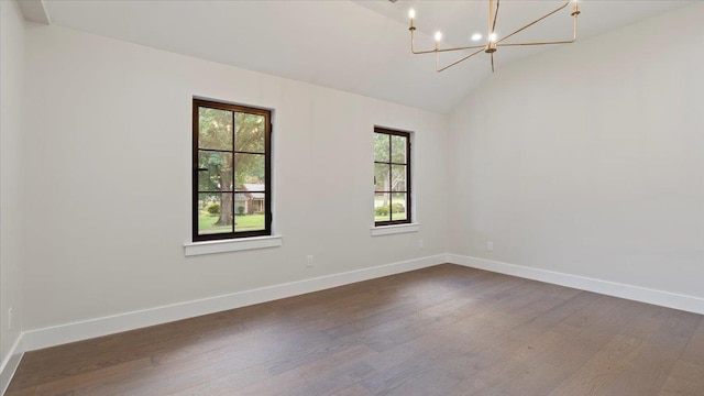 unfurnished room with dark hardwood / wood-style flooring, vaulted ceiling, and an inviting chandelier