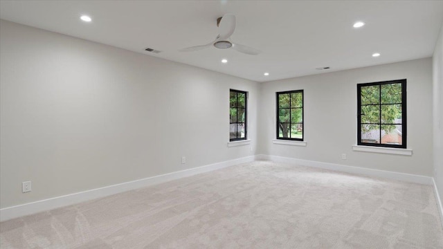 empty room featuring light carpet and ceiling fan