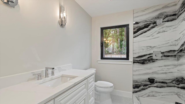 bathroom featuring a shower, vanity, and toilet