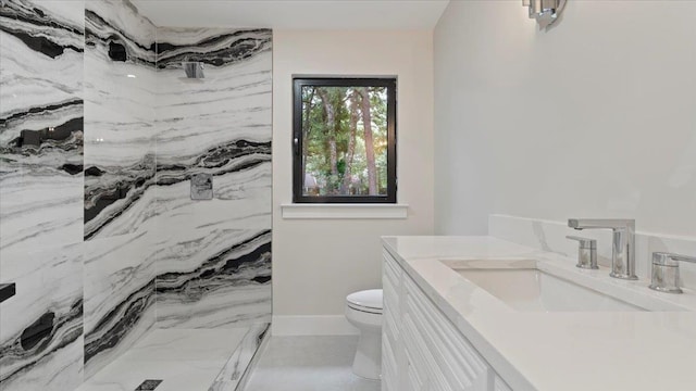 bathroom with a shower, vanity, and toilet