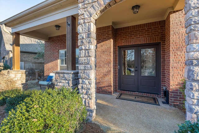 entrance to property with covered porch and french doors