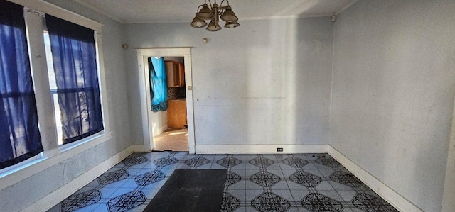 interior space with a chandelier, a healthy amount of sunlight, and crown molding