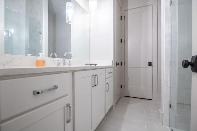 bathroom with tile patterned flooring, vanity, and an enclosed shower