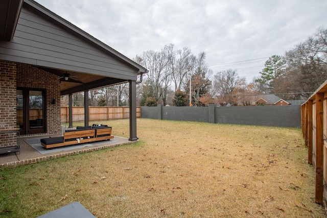 view of yard with ceiling fan and a patio