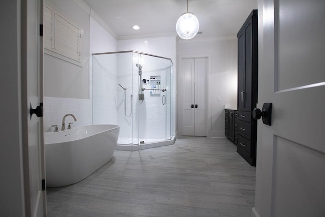 bathroom featuring vanity, ornamental molding, and plus walk in shower