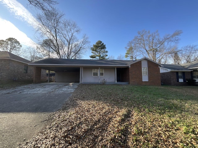 ranch-style house with a front lawn and a carport