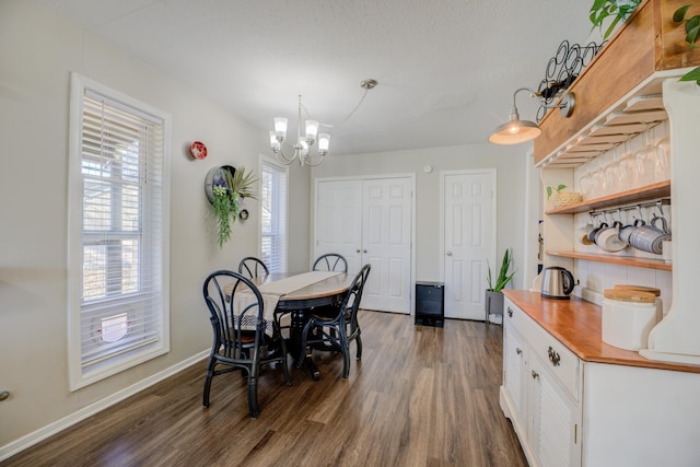 dining room featuring a chandelier and dark wood-type flooring