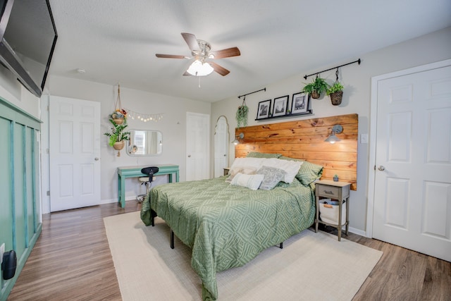 bedroom featuring ceiling fan and wood-type flooring