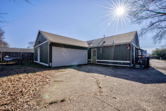 rear view of property featuring a garage