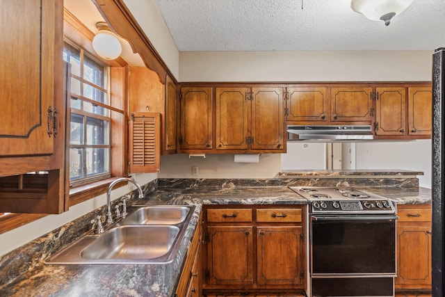 kitchen featuring a textured ceiling, plenty of natural light, electric stove, and sink