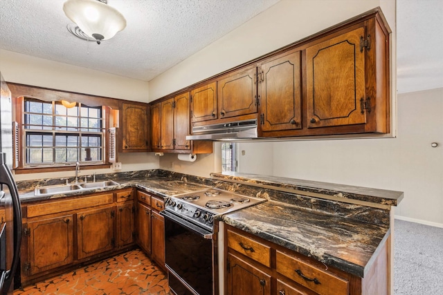 kitchen with a textured ceiling, range with electric cooktop, dark stone countertops, and sink