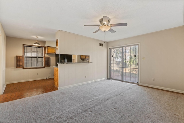 unfurnished living room featuring ceiling fan