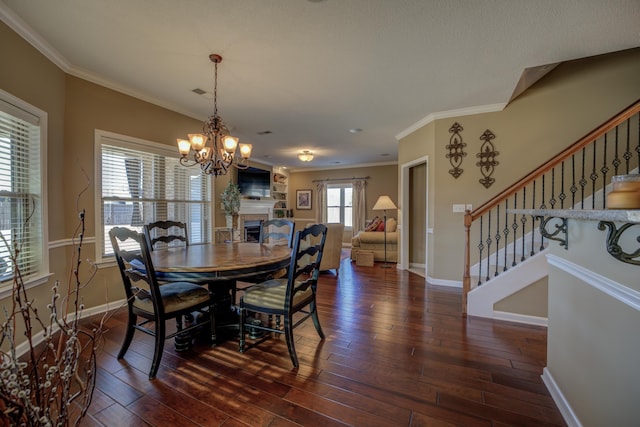 dining room with an inviting chandelier, dark hardwood / wood-style floors, and ornamental molding