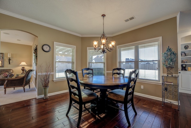 dining room featuring a textured ceiling, a notable chandelier, dark hardwood / wood-style floors, and crown molding