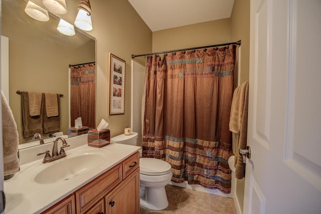 bathroom with tile patterned floors, vanity, toilet, and walk in shower